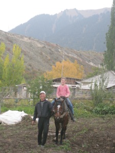 Samat, our landlord and neighbor, teaching my daughter to plow the potato field